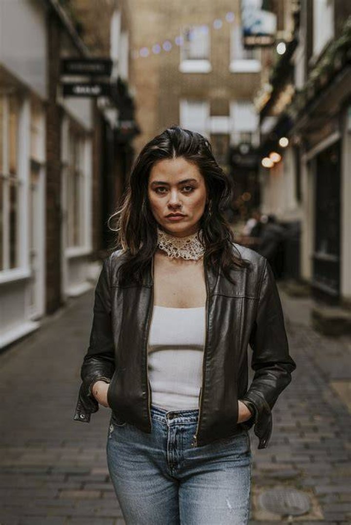 a person wearing a leather jacket and boots a person wearing a leather jacket and boots