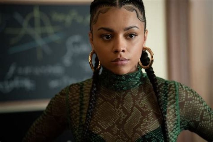 Alix Lapri as Effie Morales in 'Power Book II: Ghost' wearing a black jacket and curly ponytail