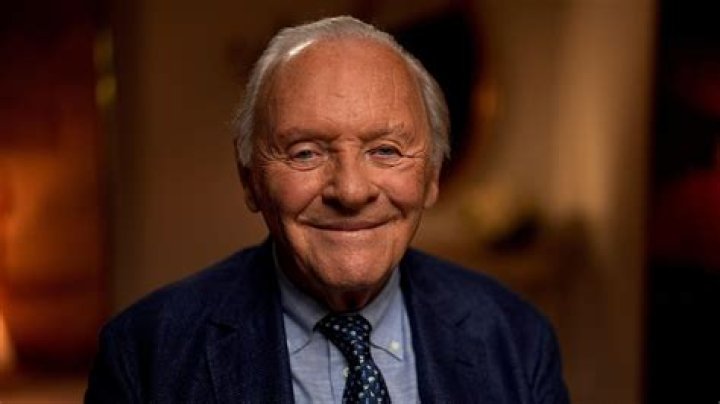 Anthony Hopkins smiling while wearing a suit.