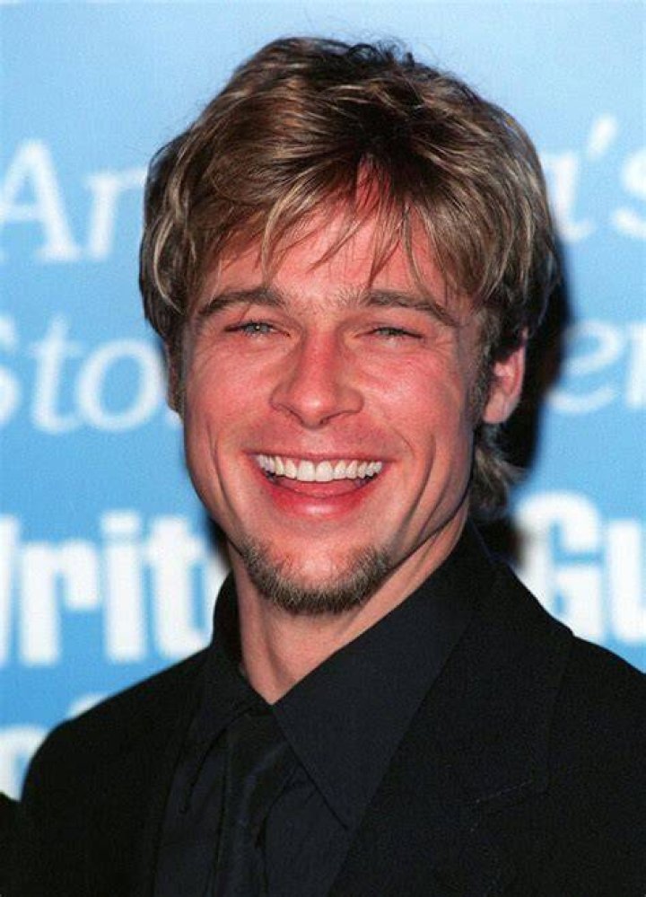 Brad Pitt smiling, turned slightly to the side