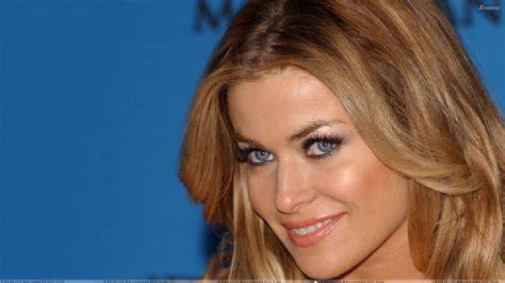 Carmen Electra smiling in front of a white background