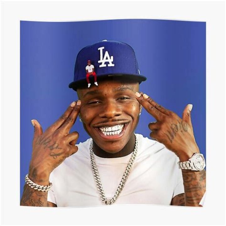 DaBaby wearing a red hat while performing on stage.