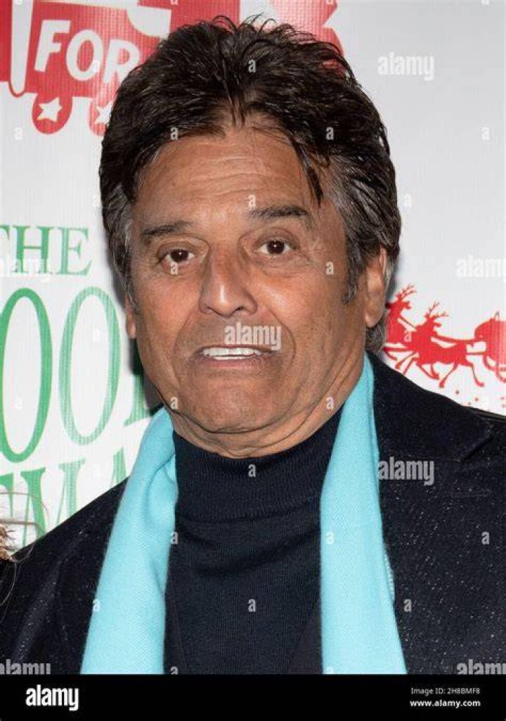 Erik Estrada smiling in front of posters of himself