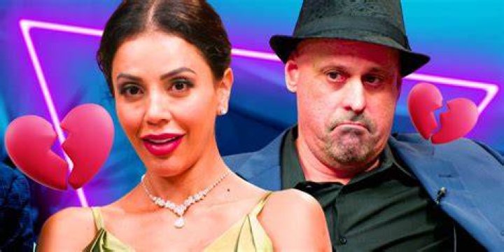 Gino looking at Jasmine as they stand in front of a rack of wedding dresses in '90 Day Fiance' Season 10