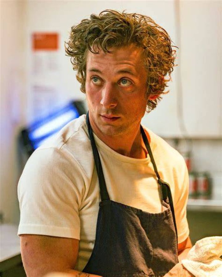 Jeremy Allen White, as Carmy who speaks 'The Bear' kitchen jargon in the FX series, sits on a counter