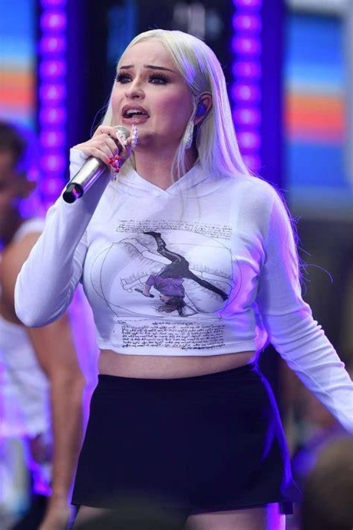 Kim Petras with a microphone