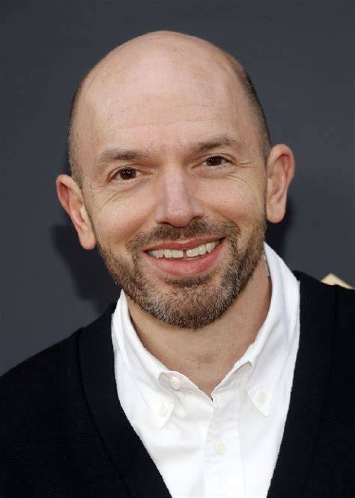 Paul Scheer as Keith, wearing a blood-spattered tux and sitting on a couch in 'Black Monday' Season 3