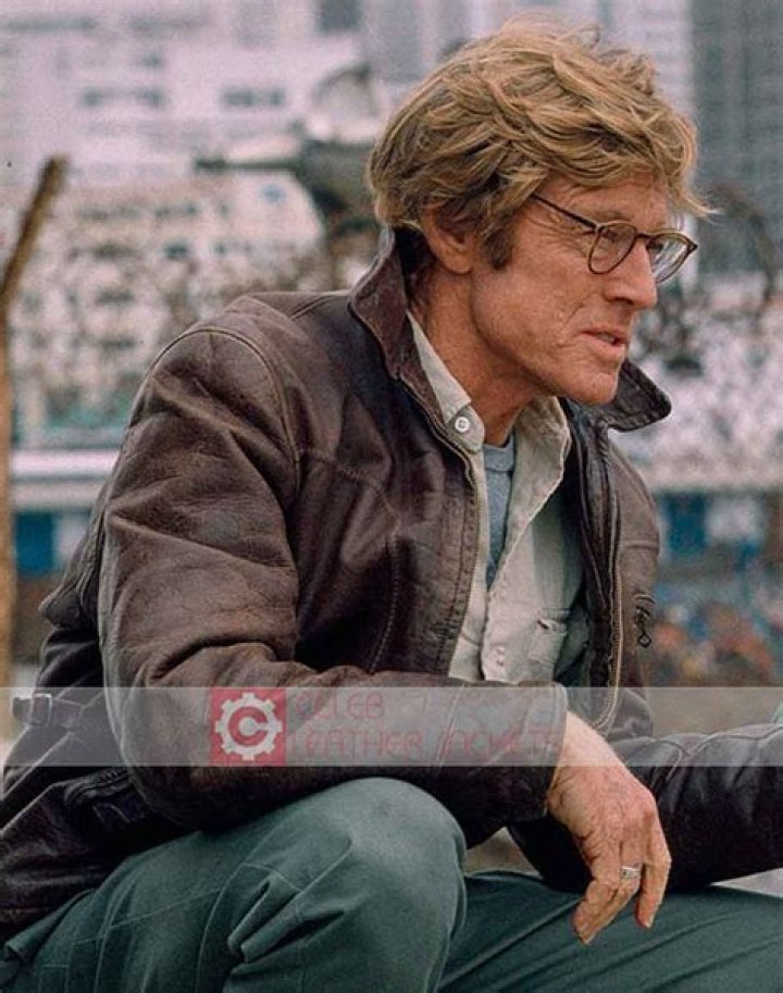 Robert Redford as Nathan Muir and Brad Pitt as Tom Bishop acting in 'Spy Game' handing binoculars