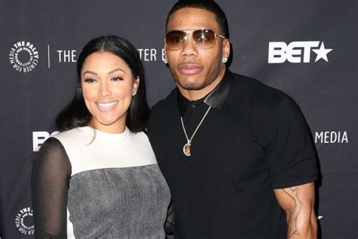 Shantel Jackson hugs Nelly while posing for a photo at a party