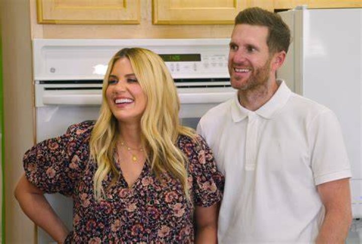 Shea 0and Syd McGee in 'Dream Home Makeover' for our article about season 4. They're standing in front of cabinets and an oven and smiling.