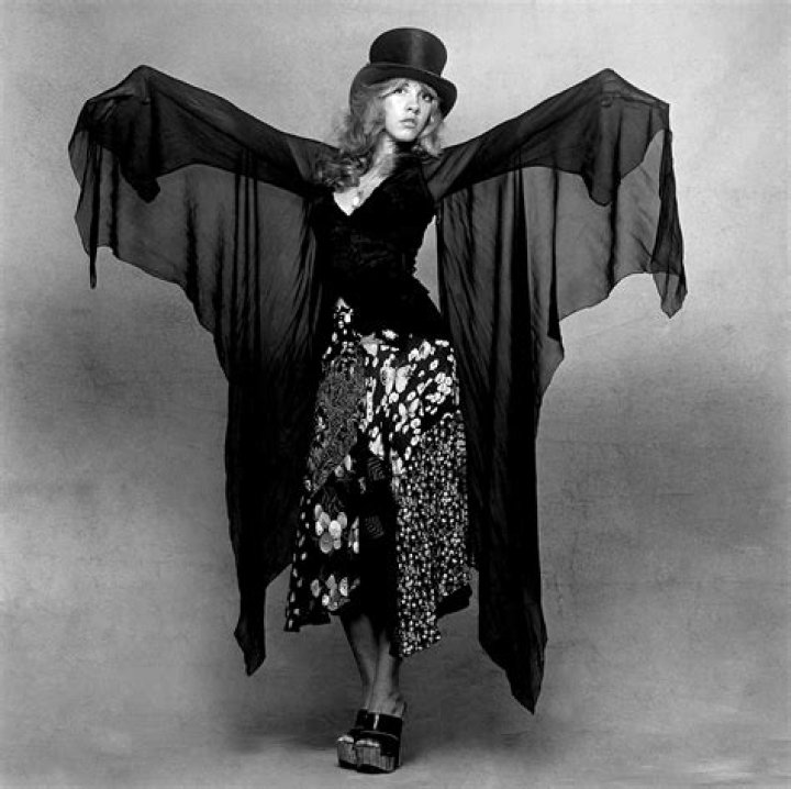 Stevie Nicks wears a black outfit while performing.
